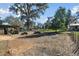 Fenced farm area with shelters, trees, and a grassy paddock at 2707 De Montmollin Rd, Plant City, FL 33565