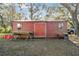 Red wooden workshop building with a workbench outside at 2707 De Montmollin Rd, Plant City, FL 33565