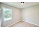 Spacious bedroom featuring wood-look vinyl flooring and large window with natural light at 1153 Chalmer Ter, Port Charlotte, FL 33953