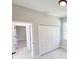 Empty bedroom with white closet doors, light gray walls, and wood-look vinyl floors at 1153 Chalmer Ter, Port Charlotte, FL 33953