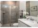 Modern bathroom featuring a glass shower, single vanity, and tiled walls at 2550 Mauritania Rd, Punta Gorda, FL 33983