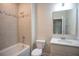 Clean and classic bathroom with tiled shower, white vanity, and neutral-toned décor at 2550 Mauritania Rd, Punta Gorda, FL 33983