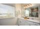 Elegant bathroom with double vanities, a large mirror, and modern light fixtures at 2550 Mauritania Rd, Punta Gorda, FL 33983