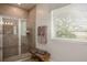 Modern bathroom with a walk-in shower, tiled walls, and window blinds for privacy at 2550 Mauritania Rd, Punta Gorda, FL 33983