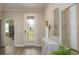 Inviting entryway with a glass-paned front door, wood-look flooring, and decorative accents at 2550 Mauritania Rd, Punta Gorda, FL 33983