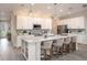 Modern kitchen with white shaker cabinets, quartz countertops, stainless steel appliances, and a large island at 2550 Mauritania Rd, Punta Gorda, FL 33983