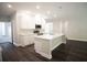 Modern kitchen featuring white shaker cabinets, stainless steel appliances, and an island with white quartz countertop at 2550 Mauritania Rd, Punta Gorda, FL 33983