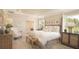Spacious main bedroom with a king-size bed, sitting area, and access to a private bathroom at 2550 Mauritania Rd, Punta Gorda, FL 33983