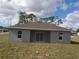 Backyard view of a single-story house with sliding glass doors and windows at 1262 Oxsalida St, Port Charlotte, FL 33952