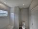 Clean bathroom with tiled walls, bathtub, toilet, and window at 1262 Oxsalida St, Port Charlotte, FL 33952