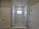 Spacious walk-in shower with white tile and modern fixtures at 1262 Oxsalida St, Port Charlotte, FL 33952