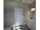 Bright bathroom featuring white vanity, tiled floor, and modern fixtures at 1262 Oxsalida St, Port Charlotte, FL 33952