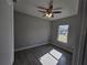Empty bedroom with gray walls, tile floor, ceiling fan, and ample natural light at 1262 Oxsalida St, Port Charlotte, FL 33952