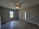 Empty bedroom with gray walls, wood-look tile floor, and ceiling fan at 1262 Oxsalida St, Port Charlotte, FL 33952