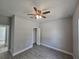 Empty bedroom with ceiling fan, wood-look tile floors, and gray walls at 1262 Oxsalida St, Port Charlotte, FL 33952