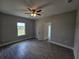 Empty bedroom with gray walls, wood-look tile floor, and ceiling fan at 1262 Oxsalida St, Port Charlotte, FL 33952