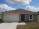 Front exterior of a single-story home with a one-car garage and a driveway at 1262 Oxsalida St, Port Charlotte, FL 33952