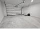 Attached garage with white door and concrete floor at 1262 Oxsalida St, Port Charlotte, FL 33952