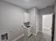 Laundry room with white cabinets, sink, and tile flooring at 1262 Oxsalida St, Port Charlotte, FL 33952