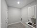 Spacious laundry room with white cabinets, sink, and ample space at 1262 Oxsalida St, Port Charlotte, FL 33952