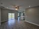 Living room with tile flooring, ceiling fan, and view of backyard through sliding glass doors at 1262 Oxsalida St, Port Charlotte, FL 33952