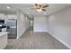 Open-concept living area with tile flooring, ceiling fan, and view of the kitchen at 1262 Oxsalida St, Port Charlotte, FL 33952