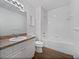 Bathroom with white vanity, sink, toilet, and bathtub/shower combination at 2061 Willow Hammock Cir # 107, Punta Gorda, FL 33983