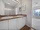 Dual vanity bathroom with updated fixtures, large mirror, and view of the bedroom at 2061 Willow Hammock Cir # 107, Punta Gorda, FL 33983