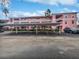 Pink apartment building exterior with covered parking at 2061 Willow Hammock Cir # 107, Punta Gorda, FL 33983