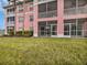 Pink building exterior with screened-in balconies or patios at 2061 Willow Hammock Cir # 107, Punta Gorda, FL 33983