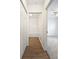 Hallway with wood-style flooring, white closet doors, and a view of the bathroom and a bedroom at 2061 Willow Hammock Cir # 107, Punta Gorda, FL 33983