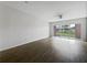 Spacious living area with wood-look floors and sliding glass doors leading to the outdoors at 2061 Willow Hammock Cir # 107, Punta Gorda, FL 33983
