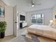 Bedroom with plush carpet, a ceiling fan, and large window with blinds at 2061 Willow Hammock Cir # 107, Punta Gorda, FL 33983