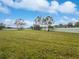 Spacious grassy common area under blue skies at 2061 Willow Hammock Cir # 107, Punta Gorda, FL 33983