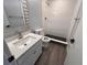 Modern bathroom with a walk-in shower, updated vanity, and wood-look flooring at 314 Spring Lakes Blvd # 314-U, Bradenton, FL 34210