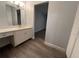 Clean bathroom with white vanity, wood-look flooring, and view to adjacent room at 314 Spring Lakes Blvd # 314-U, Bradenton, FL 34210