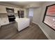 Updated kitchen with stainless steel appliances, a white island, and wood-look flooring at 314 Spring Lakes Blvd # 314-U, Bradenton, FL 34210
