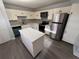 Modern kitchen featuring stainless steel appliances, white cabinets, and an island at 314 Spring Lakes Blvd # 314-U, Bradenton, FL 34210