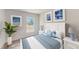 Bedroom with white and blue bedding, matching nightstands, and decorative wall art at 2184 Hyatt Dr, Port Charlotte, FL 33948