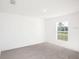Empty bedroom with neutral carpet and large window at 2184 Hyatt Dr, Port Charlotte, FL 33948