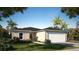 Charming single-story home with a two-car garage and landscaped front yard at 2184 Hyatt Dr, Port Charlotte, FL 33948