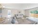 Open-concept great room with living and dining areas, glass coffee table, and sliding doors at 2184 Hyatt Dr, Port Charlotte, FL 33948