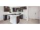 Well-appointed kitchen with island, dark cabinets, and stainless steel appliances at 2184 Hyatt Dr, Port Charlotte, FL 33948