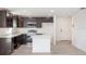 Spacious kitchen featuring dark wood cabinets, stainless steel appliances, and an island at 2184 Hyatt Dr, Port Charlotte, FL 33948