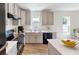 Modern kitchen featuring gray shaker-style cabinets, black appliances, and white countertops at 2184 Hyatt Dr, Port Charlotte, FL 33948