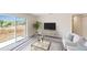 Living room with sliding glass door, white sofa, glass coffee table, and area rug at 2184 Hyatt Dr, Port Charlotte, FL 33948