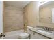 Updated bathroom with granite vanity and tile shower/tub at 3723 N Garrison St, Tampa, FL 33619
