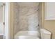 Bathroom with marble tile shower and bathtub at 3723 N Garrison St, Tampa, FL 33619