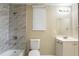 Updated bathroom with marble tile shower and vanity at 3723 N Garrison St, Tampa, FL 33619