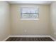 Bright bedroom with wood-look floors and a window at 3723 N Garrison St, Tampa, FL 33619